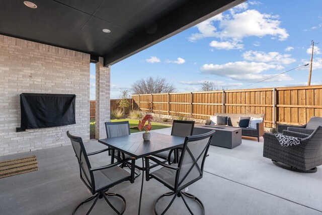 view of patio / terrace with an outdoor living space with a fire pit