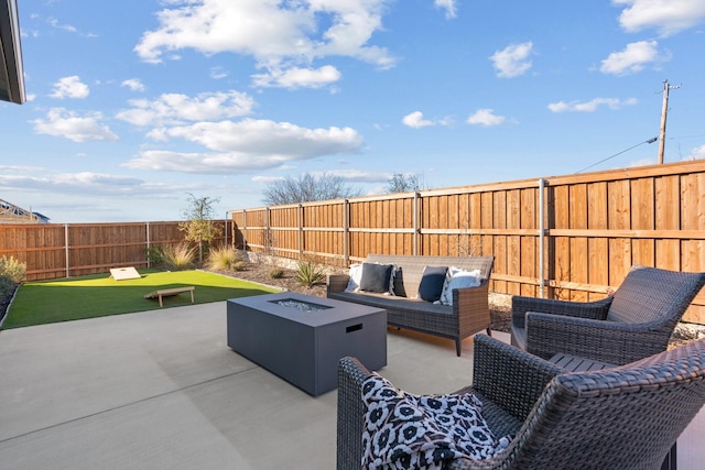 view of patio / terrace featuring a fenced backyard and an outdoor living space with a fire pit