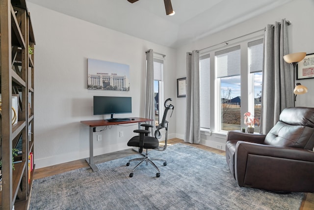 office space with vaulted ceiling, ceiling fan, baseboards, and wood finished floors