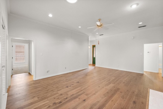 empty room featuring ceiling fan, light hardwood / wood-style flooring, and crown molding