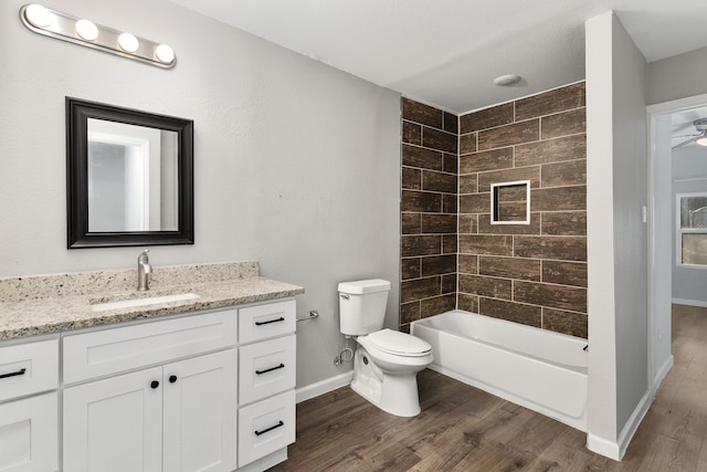 1206 W Hanna St, Denison, TX 75020 - bathroom with wood finished floors, vanity, tub / shower combination, and a ceiling fan