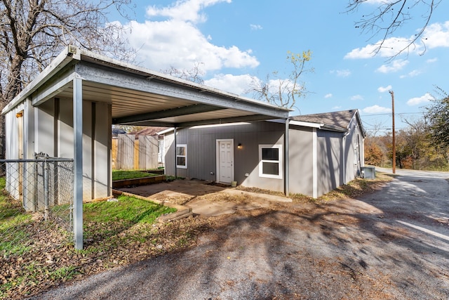 1206 W Hanna St, Denison, TX 75020 - view of front of property with central AC, fence, and a carport