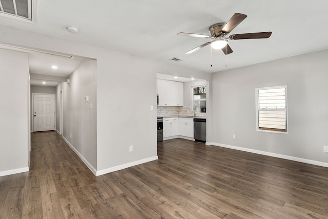 interior space with dark wood-type flooring, a sink, visible vents, and baseboards