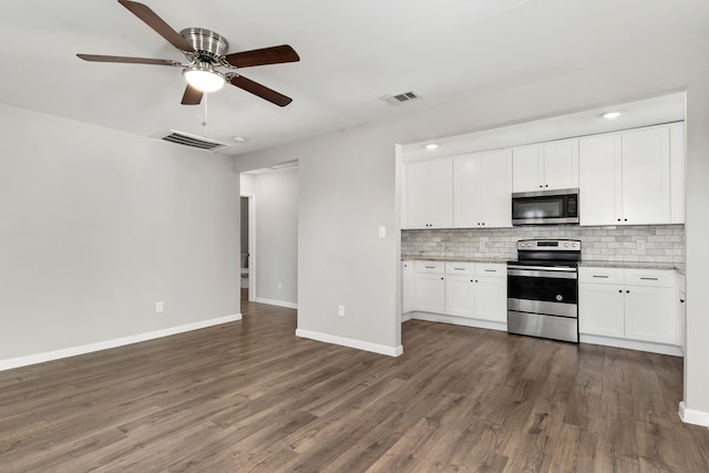 kitchen featuring visible vents, appliances with stainless steel finishes, dark wood-type flooring, and backsplash