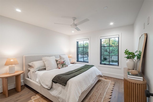 bedroom with light wood-type flooring and ceiling fan