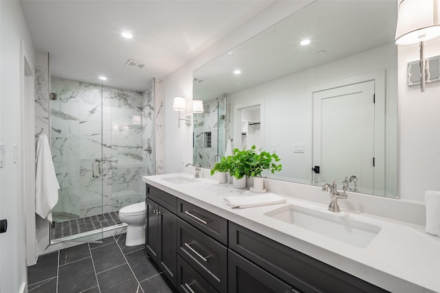 bathroom featuring a shower with door, tile patterned floors, toilet, and vanity