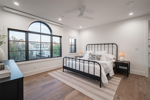 bedroom with wood-type flooring and ceiling fan