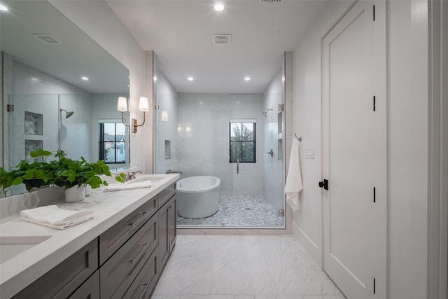 bathroom featuring vanity and shower with separate bathtub