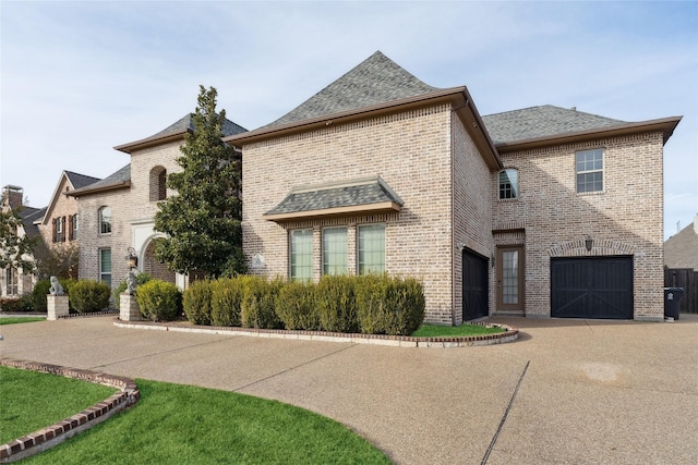 french country home with a garage