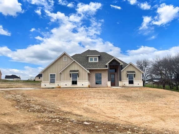 view of front of property featuring board and batten siding and a shingled roof