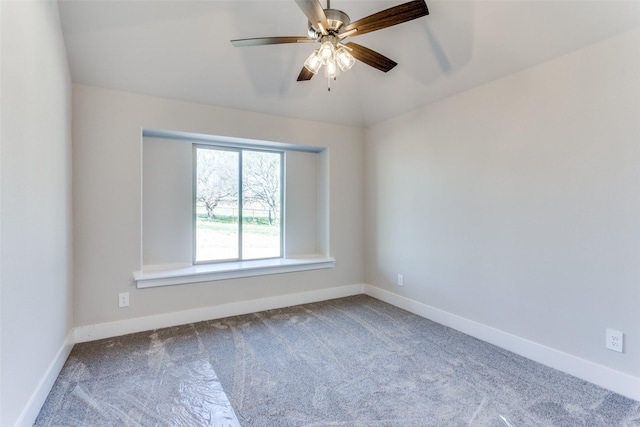 empty room featuring ceiling fan, carpet, baseboards, and vaulted ceiling