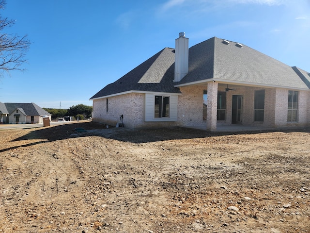 rear view of property with ceiling fan