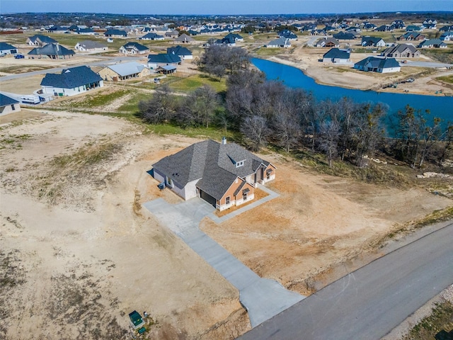 bird's eye view with a residential view and a water view