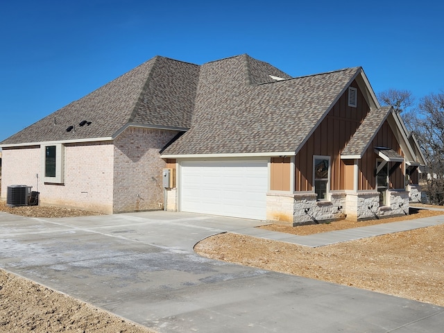 view of front of house featuring a garage and central AC unit