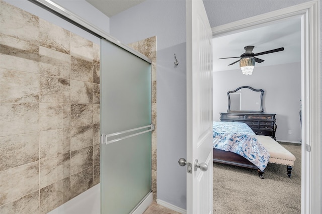 bathroom with ceiling fan and a shower with shower door