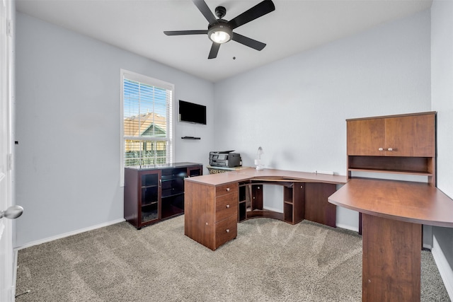 carpeted home office featuring ceiling fan