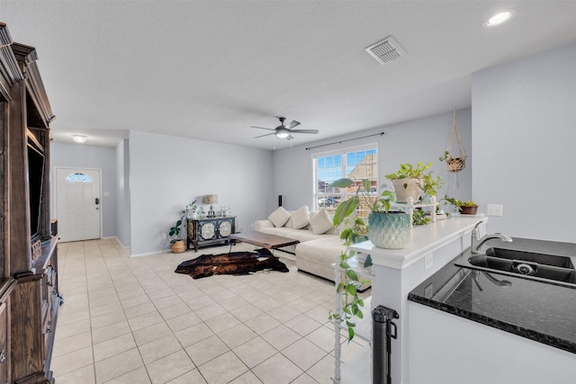 tiled living room with sink and ceiling fan