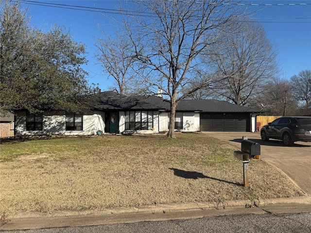 view of front of property featuring a front yard and a garage