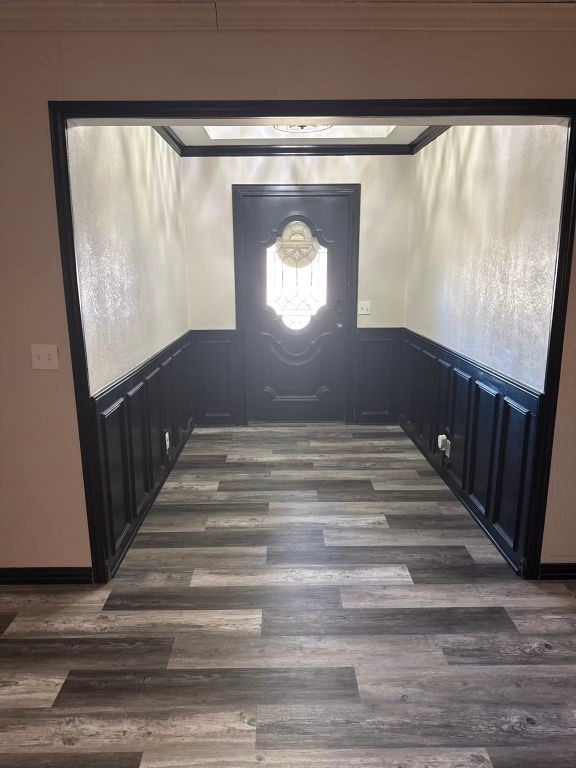 entrance foyer with dark hardwood / wood-style flooring and ornamental molding