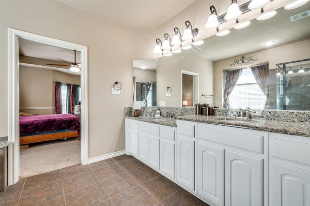 bathroom with a shower with shower door, ceiling fan, and vanity