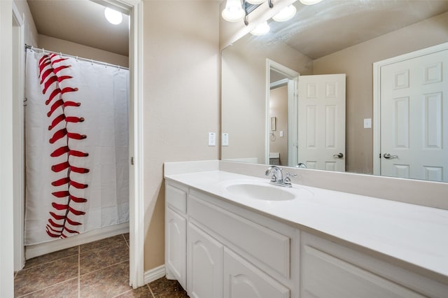 bathroom featuring curtained shower and vanity