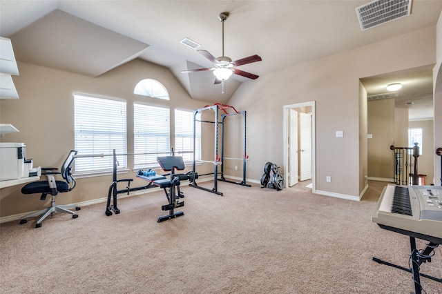 workout room featuring ceiling fan, light colored carpet, and vaulted ceiling