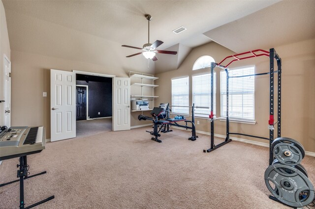 exercise area featuring ceiling fan, carpet, and lofted ceiling