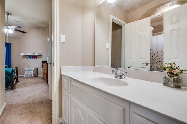 bathroom with lofted ceiling and vanity