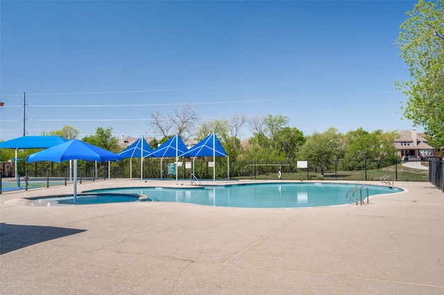 view of pool with a patio and a hot tub