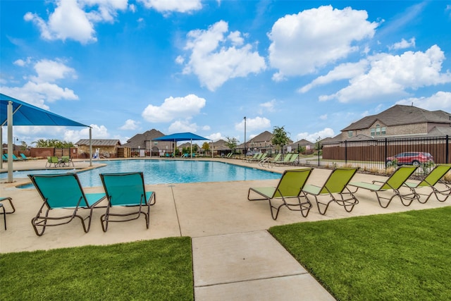 view of pool featuring a patio area and a yard