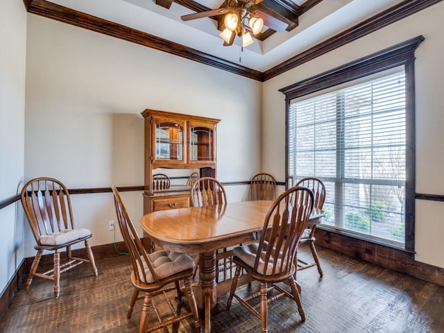 dining room featuring dark hardwood / wood-style flooring, ceiling fan, and ornamental molding