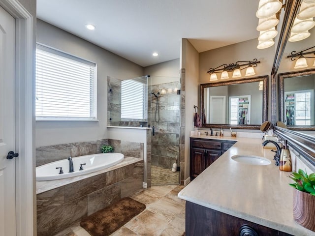 bathroom with independent shower and bath and vanity