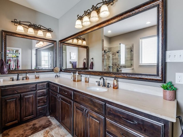 bathroom with walk in shower and vanity