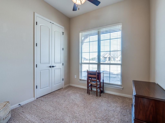 living area featuring ceiling fan and light carpet