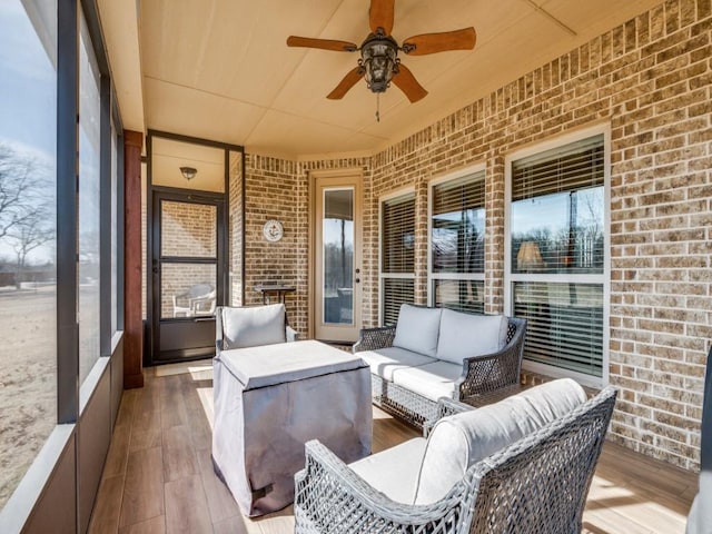 sunroom with a wealth of natural light and ceiling fan