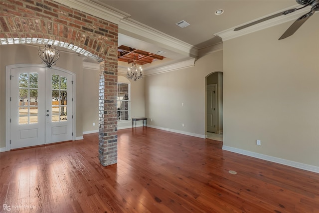 interior space featuring beamed ceiling, dark hardwood / wood-style flooring, coffered ceiling, crown molding, and french doors