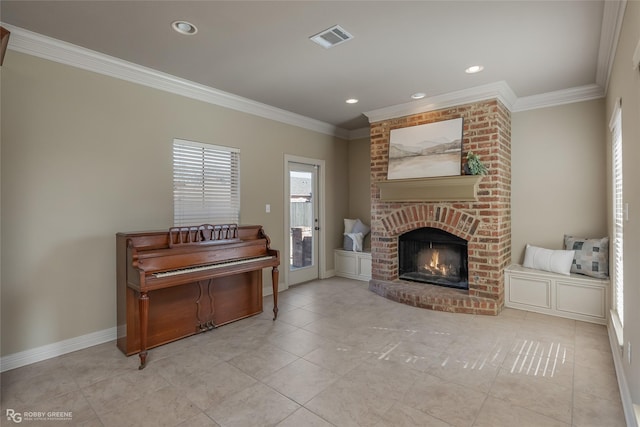 interior space with ornamental molding and a brick fireplace