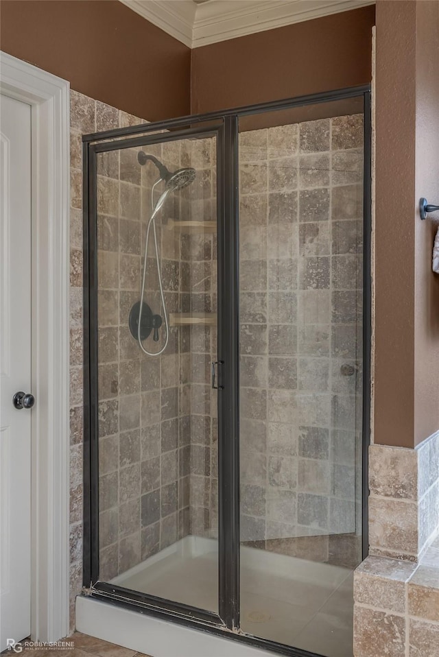 bathroom with ornamental molding and walk in shower