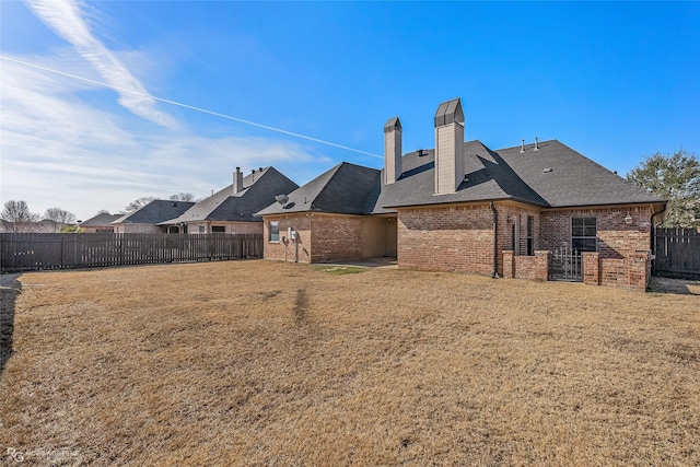 rear view of property with a yard