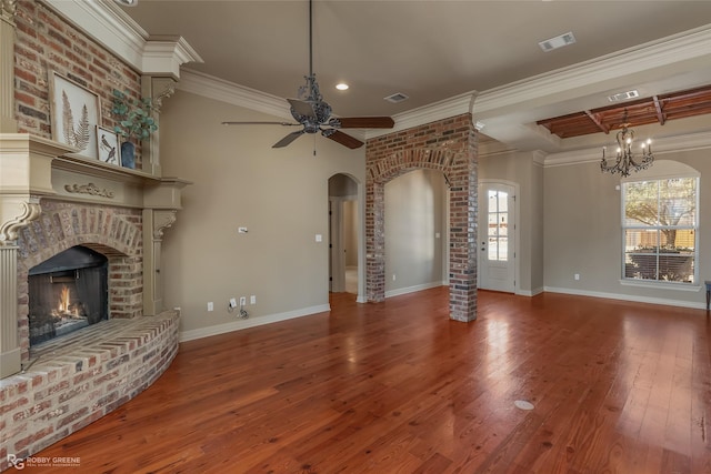 unfurnished living room with hardwood / wood-style flooring, crown molding, ceiling fan, and a fireplace