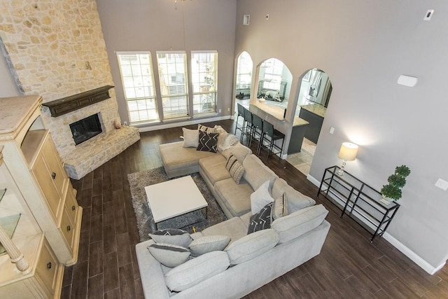 living room with a high ceiling and a fireplace