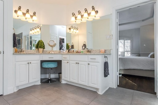 bathroom with tile patterned floors and vanity