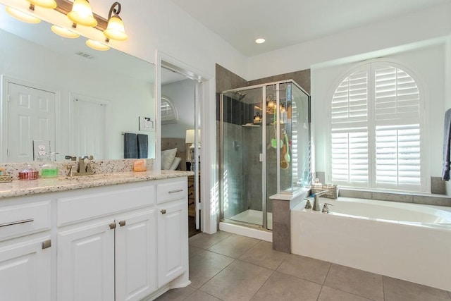 bathroom with vanity, shower with separate bathtub, an inviting chandelier, and tile patterned flooring