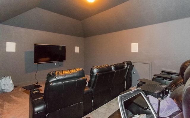 carpeted home theater room with lofted ceiling