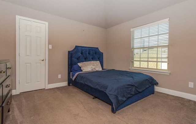 carpeted bedroom featuring vaulted ceiling