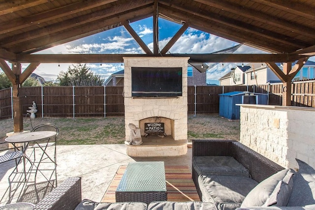 view of patio featuring an outdoor stone fireplace