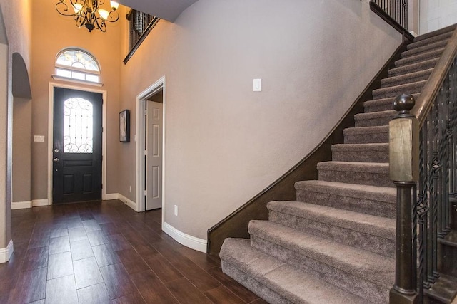 entryway featuring a notable chandelier and a towering ceiling