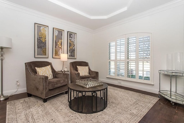 sitting room featuring hardwood / wood-style floors, a tray ceiling, and ornamental molding