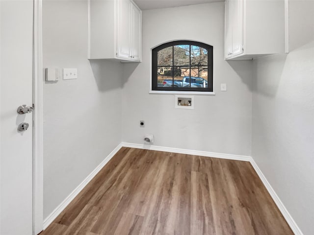 laundry room featuring washer hookup, cabinets, wood-type flooring, and hookup for an electric dryer