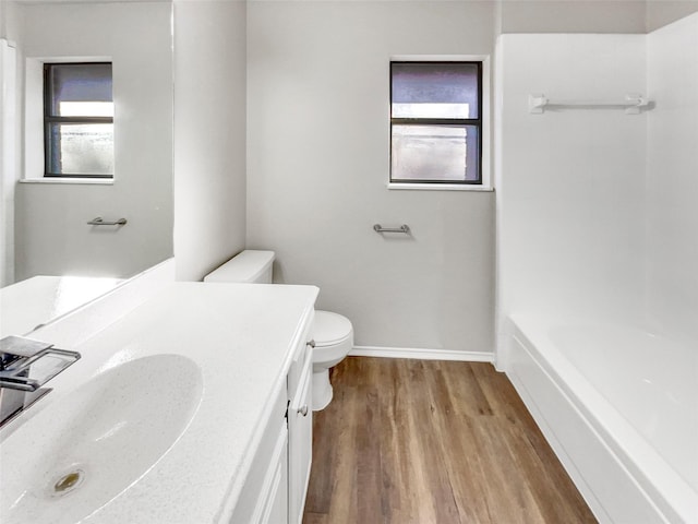 bathroom featuring vanity, hardwood / wood-style flooring, and toilet